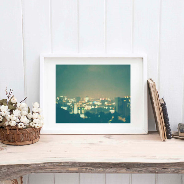 Framed Los Angeles cityscape photo, with colorful twinkly lights.