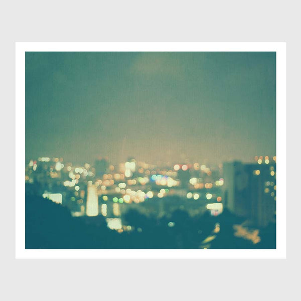 Bokeh photograph of Hollywood at Night. With Blue Green background and Rainbow colors.