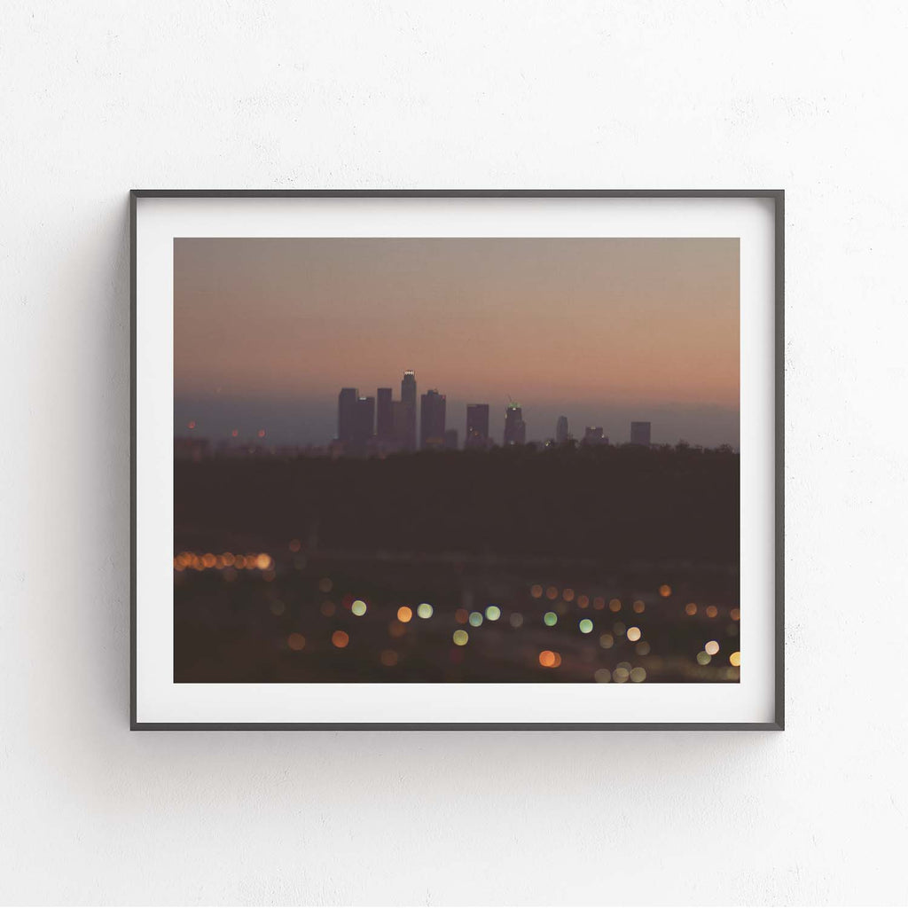 Framed print of the Los Angeles skyline at night . With Bokeh lights.