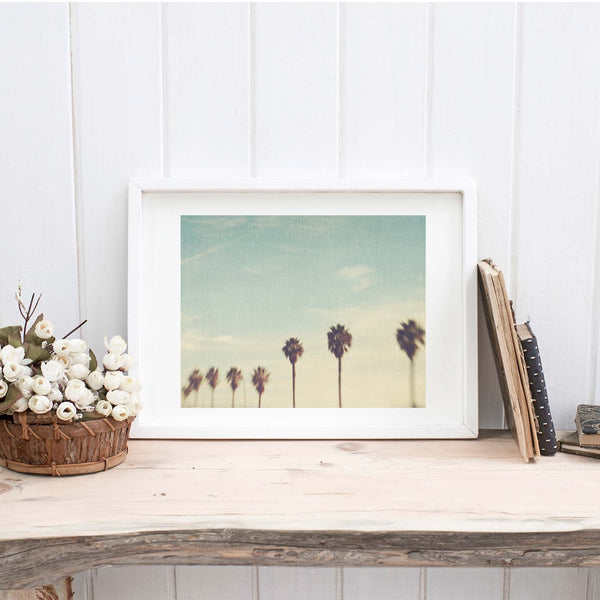 Palm trees and blue sky photo in a white frame. Taken in California.