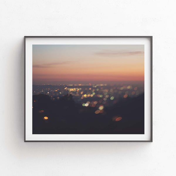 Framed LA skyline at sunset with bokeh lights